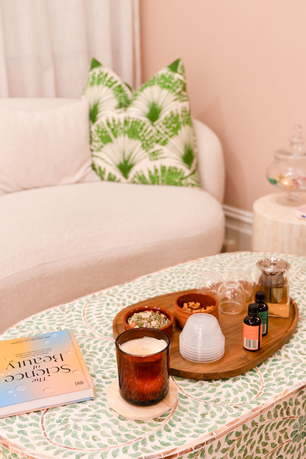 Relaxation lounge with candle, tea, and beauty book